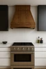 36 inch pyramid shape copper hood for gas stove in modern kitchen, warm patina canopy above range with clean cabinetry and minimal lines