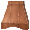 Angled view of a hammered copper range hood with straight sides, riveted panel straps, and curved front apron