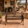 Horse medallion aluminum rustic garden bench with bronze finish on a ranch patio