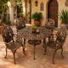 Aluminum dining furniture sets with bronze finish and cactus design in a Spanish courtyard