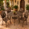 Aluminum dining furniture sets with bronze finish and cactus design in a Spanish courtyard