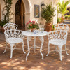 White heart scroll aluminum garden chair with romantic patio design in a hacienda courtyard