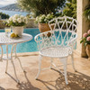 White heart scroll aluminum garden chair with romantic patio design beside a poolside terrace