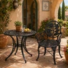 Black sunflower aluminum garden chair with ornate floral backrest on a Mediterranean patio
