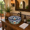 Mexican talavera floral cobalt bath bathroom sink placed in a hacienda interior bathroom with window