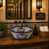 Talavera bath cone shape vessel sink with flowers placed in restaurant restroom with artisan atmosphere