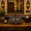 Talavera bath sink blue floral pattern design featured in a restaurant restroom with decorative tile accents