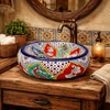 Mexican talavera donut vessel bathroom sink handcrafted design in rustic bathroom with wood vanity and warm textures