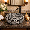 Round talavera vessel Mexican bathroom sink black white in restaurant restroom with elegant decor