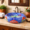Blue dotted talavera vessel Mexican bathroom sink design in Spanish Revival bathroom with stucco and wood vanity