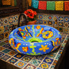 Talavera vessel Mexican bathroom sink colorful fish design featured in restaurant restroom with vibrant Mexican decor