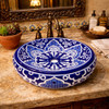 Talavera bathroom vessel sink blue white floral design in hacienda interior with warm textures