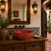 Red petal talavera vessel sink round bathroom featured in a hacienda interior with earthy tones and traditional elements