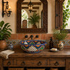 Talavera vessel sink round blue arch floral design in hacienda interior with rustic materials and traditional details