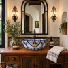 Talavera vessel sink round blue floral pattern design in Spanish Revival bathroom with tile walls and warm textures