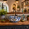 Talavera vessel sink round blue floral pattern design in kitchen bar setup with wood counter and decorative accents