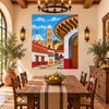 Talavera tile mural colonial church in a rustic dining room with wood furniture and pottery.