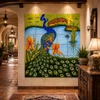 Talavera tile mural peacock garden in a boutique hotel with artisan decor and warm lighting.
