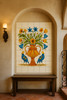 Vase and birds talavera tile mural enhancing a Spanish Revival space with arched walls and wrought-iron details
