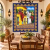 Talavera tile mural colonial street houses in a rustic dining room with handcrafted decor.