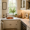 Round hammered copper bar sink in a butler pantry with bright walls, window, and brass faucet