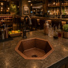 Hammered Copper Bar Sink Six-Sided Design featured in a warm restaurant bar setting with cocktail tools and ambient lighting