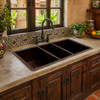 Large undermount triple-bowl copper kitchen sink in a hacienda kitchen with Talavera tile