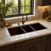 Large undermount triple-bowl copper kitchen sink in a luxury kitchen with custom cabinetry