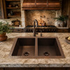 Rustic hand-hammered 50/50 copper kitchen sink in a rustic kitchen with wood cabinetry
