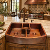 Hand-hammered triple basin copper kitchen sink with functional artisan design in an artisan farmhouse