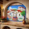 Mexican talavera tile mural village well scene featured in Spanish Revival interior with arches