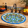 Oval mexican talavera green floral bathroom sink installed in Mediterranean kitchen with stucco wall and tile backsplash