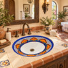 Oval Mexican floral lattice with white bottom bathroom sink in a Spanish hacienda bath