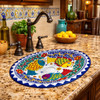 Oval talavera bathroom sink colorful fish design installed in Mediterranean kitchen bar with rustic cabinetry