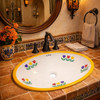 Mexican oval bathroom sink yellow tulip design in a Spanish Revival bathroom with terracotta tile and wrought iron accents