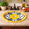 Oval talavera yellow flower mexican bathroom sink installed in Mediterranean kitchen with stone countertop and tile backsplash