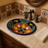 Talavera medallion mexican bathroom sink adding handcrafted color and charm inside a Spanish Revival bathroom