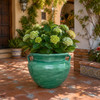 Green ceramic Talavera planter with handles decorating a sunlit Spanish patio garden