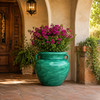 Green Talavera planter with lush foliage displayed in a warm hacienda home entryway