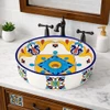 Talavera above counter bathroom sink floral geometric design in bathroom vanity with clean tiles and natural light