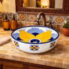 Talavera above counter Mexican bathroom sink yellow flower in restaurant restroom with warm tones and artisan interior design