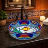 Talavera above counter fish design round vessel sink in restaurant restroom setting