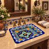Rectangular talavera bathroom sink intricate floral geometric design in Spanish Revival bathroom with tile accents