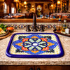 Rectangular talavera bathroom sink floral quatrefoil pattern in restaurant interior setting
