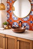 Geometric cross talavera tile accent behind a bathroom vanity highlighting symmetry and artisanal design