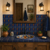 Kokopelli desert Mexican tile installed above a bathroom vanity blending desert tones with artisan texture