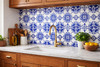 Cobalt rosette talavera tile installed as a kitchen backsplash with clean white grout lines