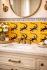 Talavera lizard silhouette tile featured behind bathroom vanity adding warmth and artisan character