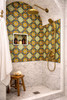 Talavera geometric medallion tile featured in bathroom shower with solid colors and balanced pattern