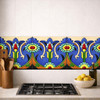 Talavera tulip floral relief border mexican tile installed as kitchen backsplash accent band